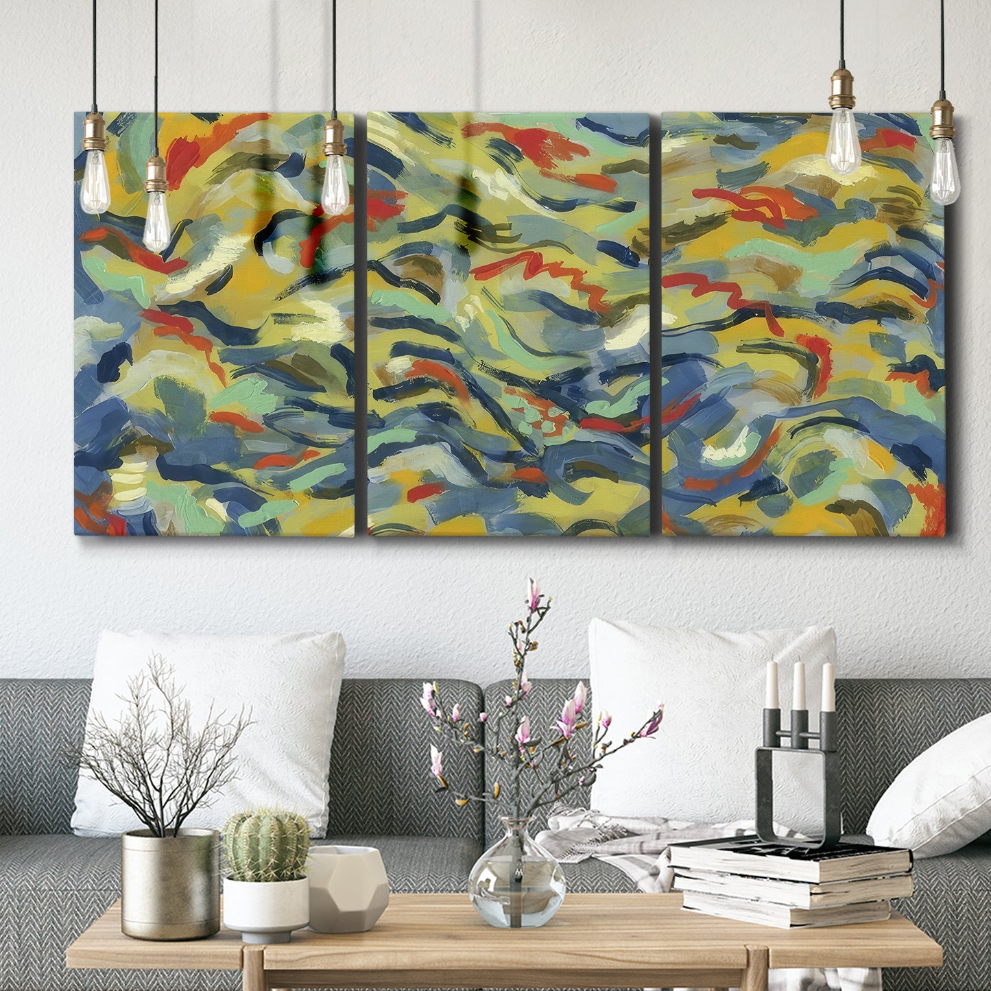 Three-panel canvas wall art featuring colorful abstract river like motion, displayed in a modern living room above seating.