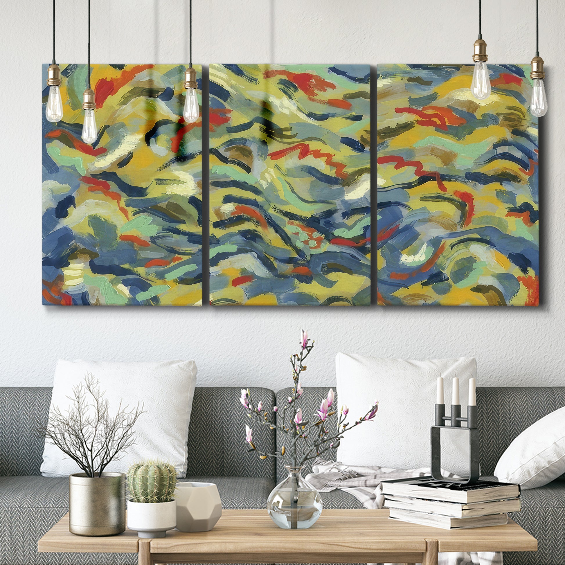 Three-panel canvas wall art featuring colorful abstract river like motion, displayed in a modern living room above seating.