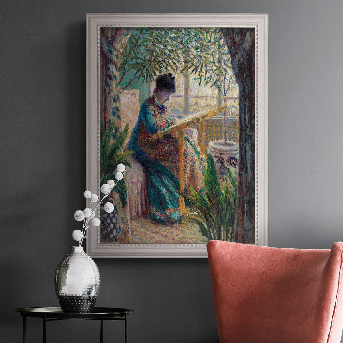 Impressionist portrait of Madame Monet sewing by Claude Monet in an ornate weathered white frame displayed in a dark-toned interior setting.