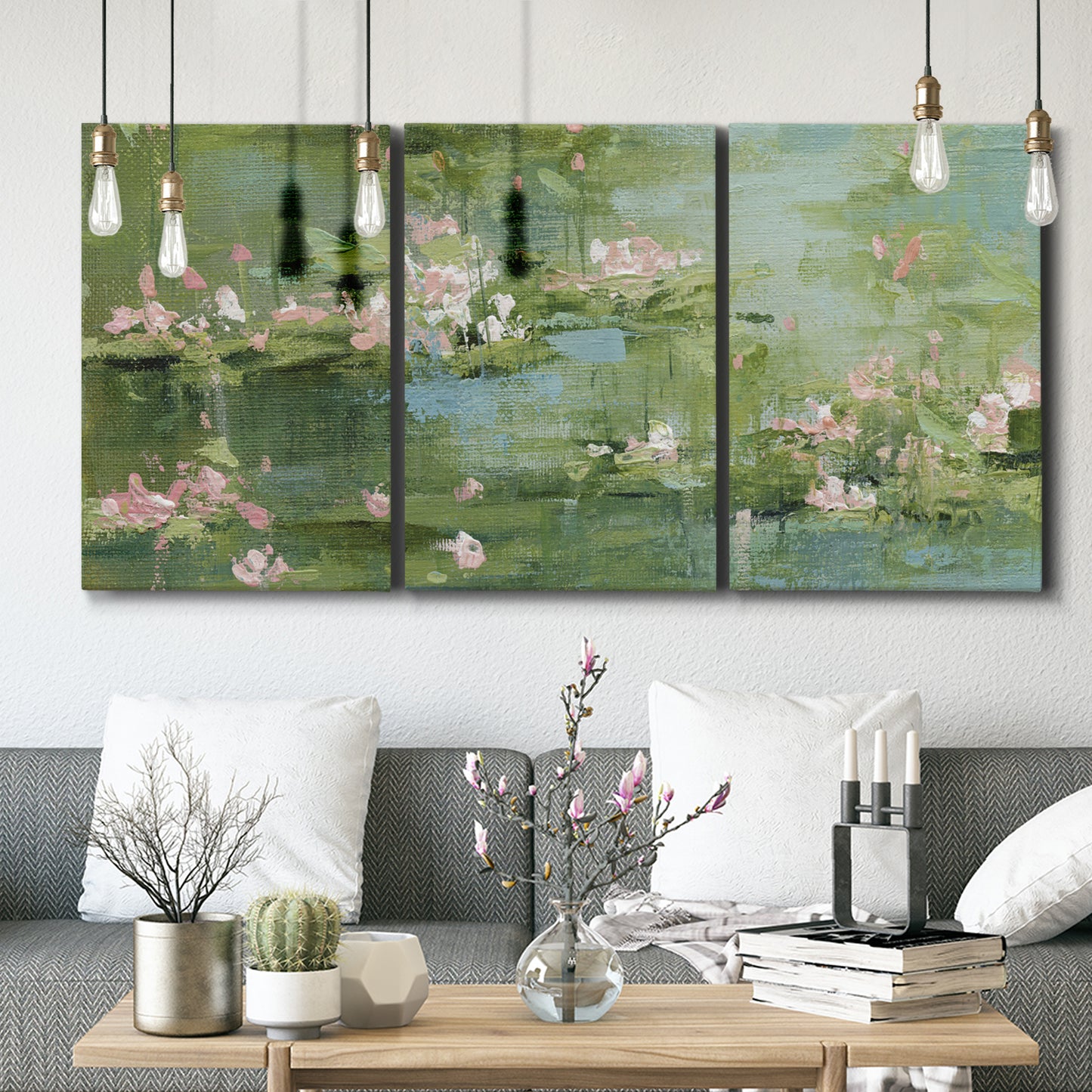 Three-panel canvas wall art featuring soft green water lilies, displayed in a modern living room above seating.