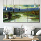 Three-panel canvas wall art featuring open meadow landscape with distant hills, displayed in a modern living room above seating.