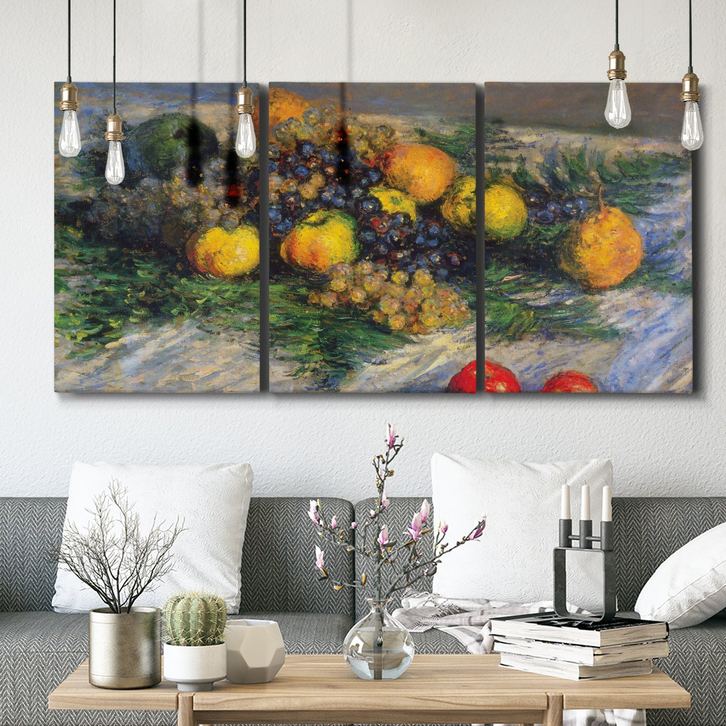 Three-panel canvas wall art featuring still life with pears and grapes, displayed in a modern living room above seating.