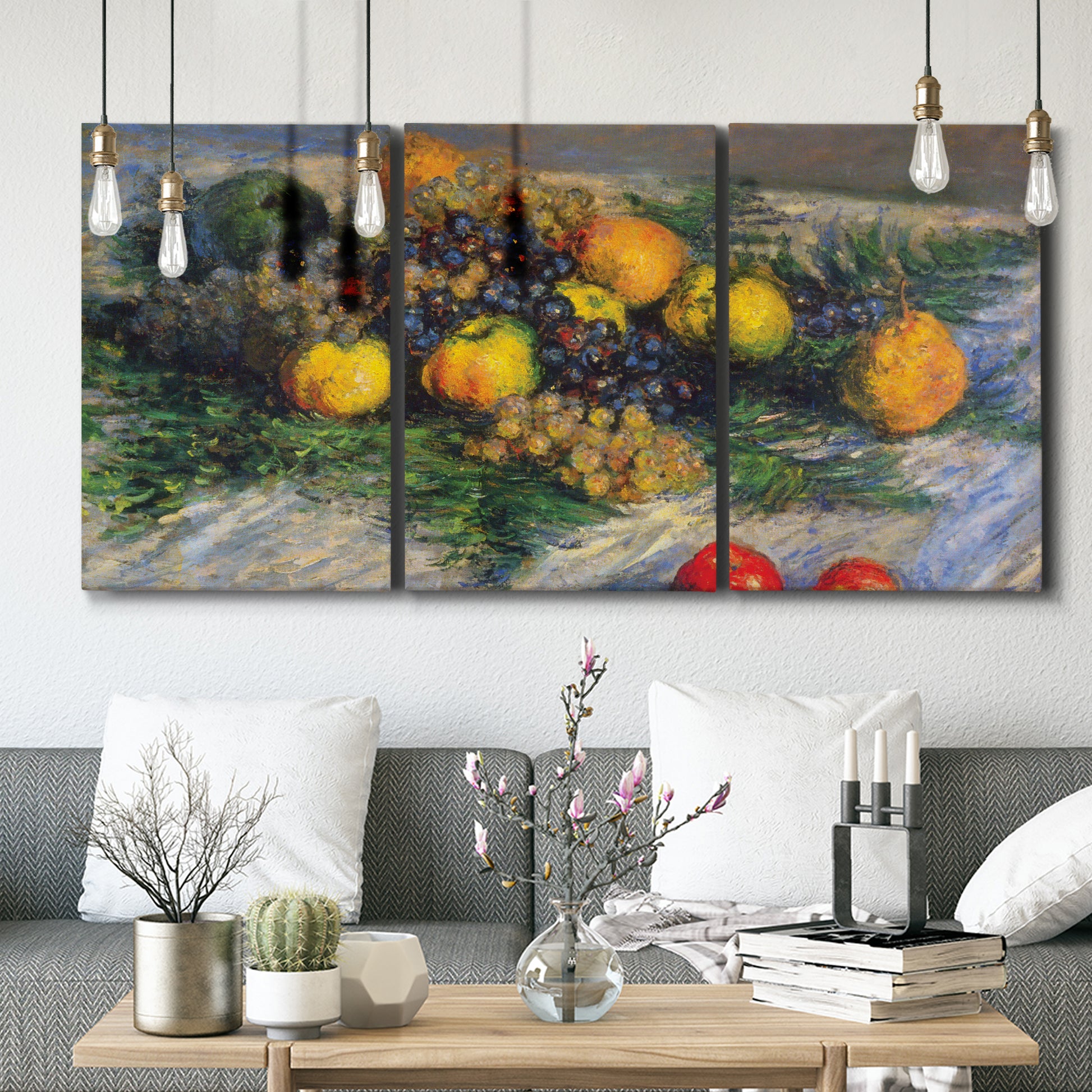 Three-panel canvas wall art featuring still life with pears and grapes, displayed in a modern living room above seating.