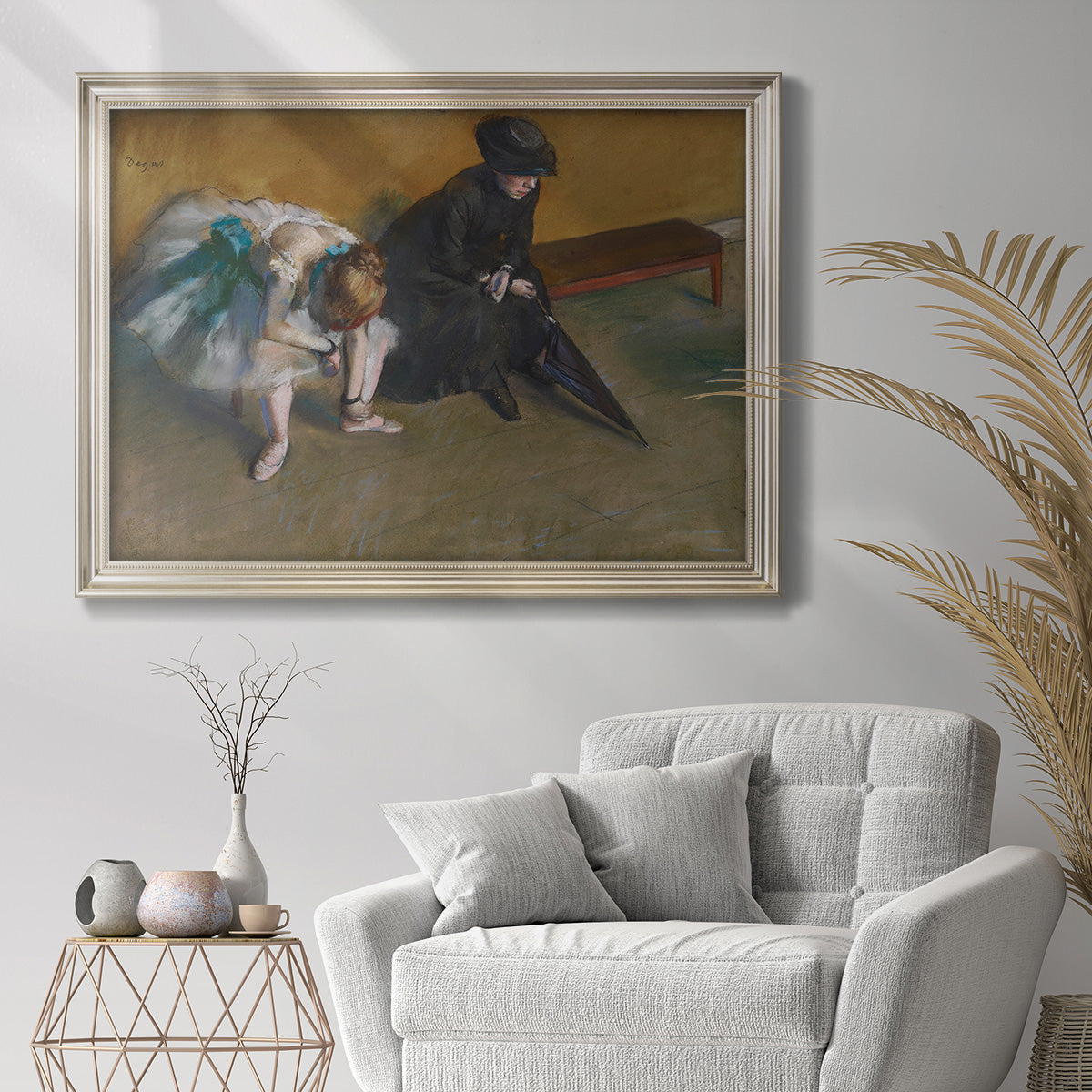 Impressionist portrait of a seated woman by Edgar Degas in an ornate champagne frame displayed in a bright interior setting.