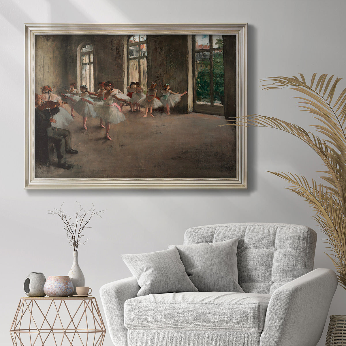 Early impressionist ballet rehearsal painting by Edgar Degas in an ornate champagne frame displayed in a bright interior setting.