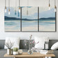 Three-panel canvas wall art featuring soft coastal shoreline landscape, displayed in a modern living room above seating.