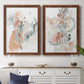 Set of two maple barnwood framed canvas prints depicting a coordinated art pair of loose blush gray and coral floral gestures rendered as abstract watercolor botanicals above a dining room sideboard.
