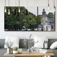 Three-panel canvas wall art featuring chapel building in rural setting, displayed in a modern living room above seating.