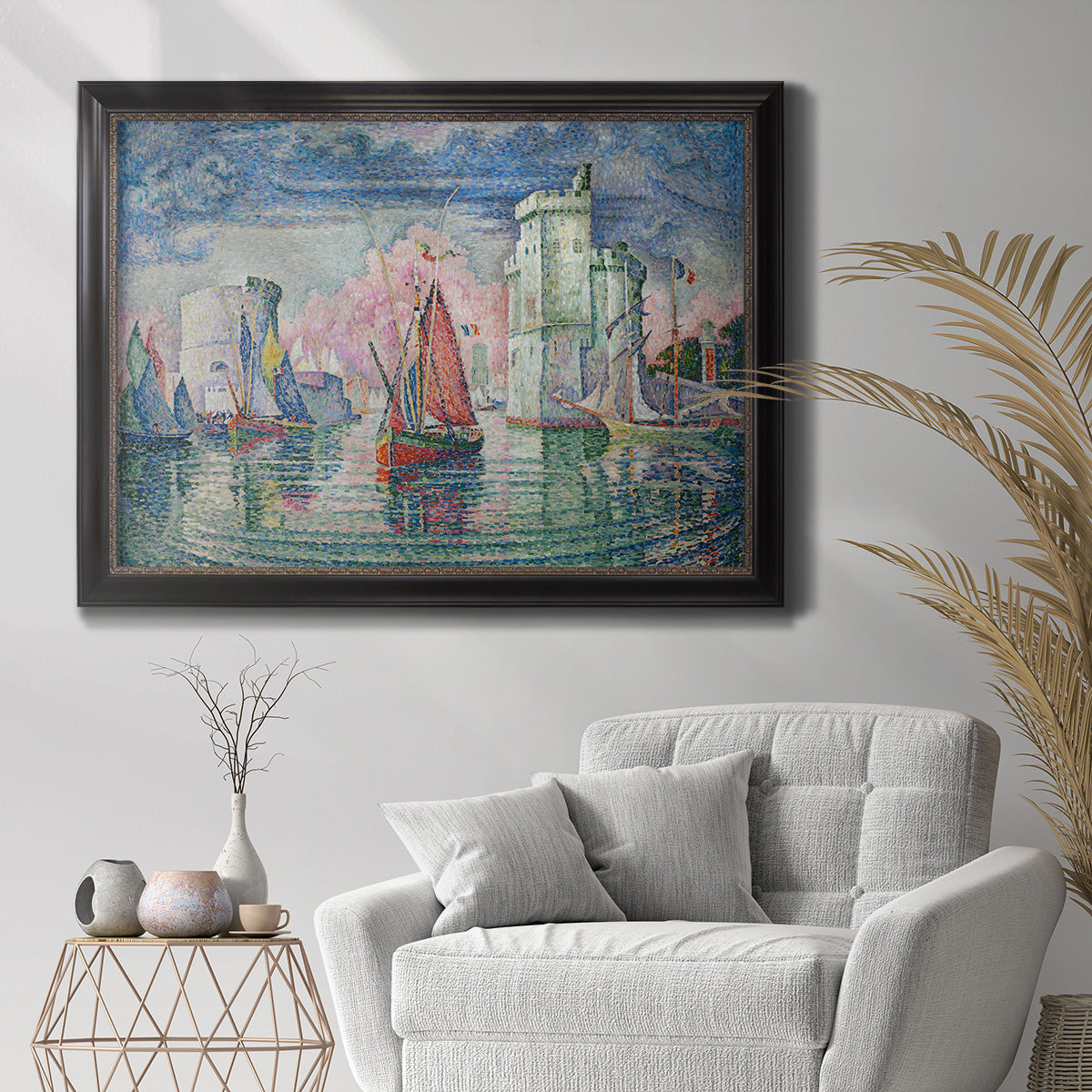 Impressionist harbor scene by Paul Signac in an ornate black frame with gilded inner detail displayed in a bright interior setting.