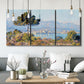 Three-panel canvas wall art featuring coastal town viewed from hillside, displayed in a modern living room above seating.