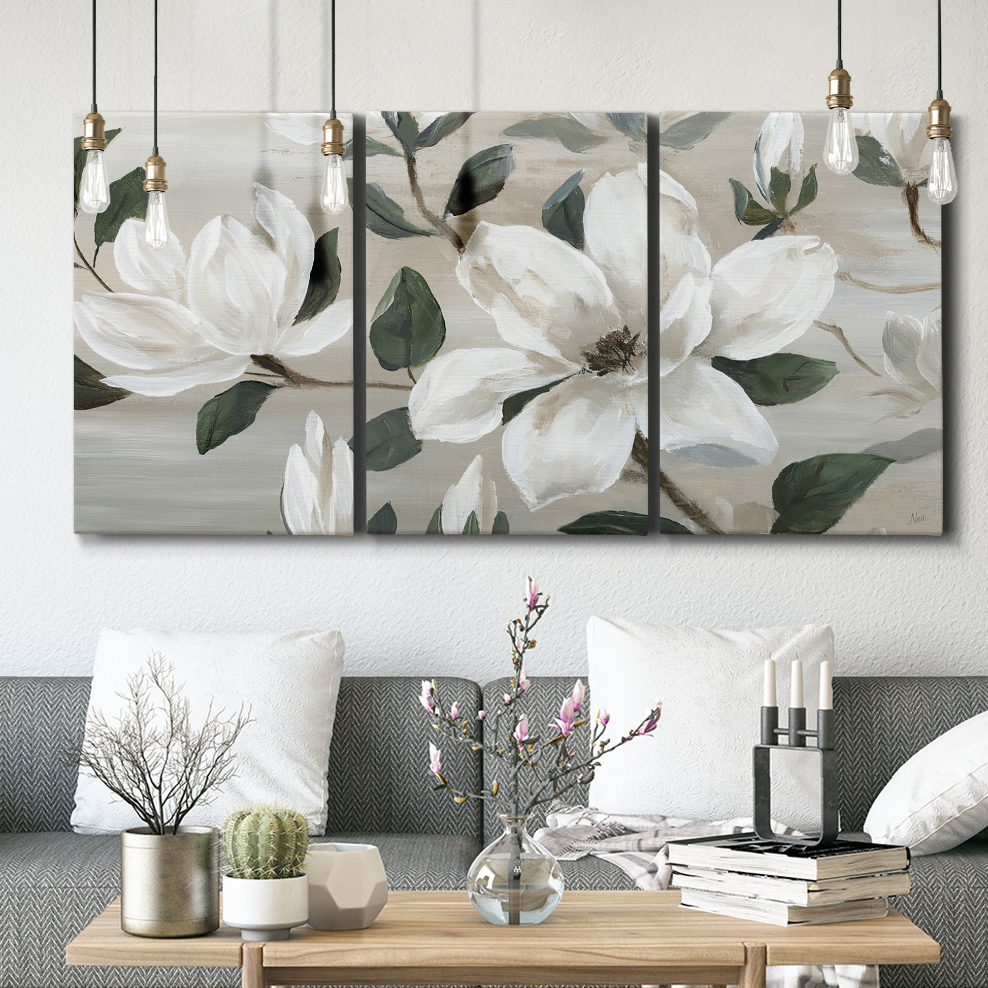 Three-panel canvas wall art featuring soft southern floral charm, displayed in a modern living room above seating.