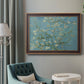 Impressionist flowering almond branch painting by Vincent van Gogh in an ornate bronzed mahogany wood frame displayed in a bright interior setting.