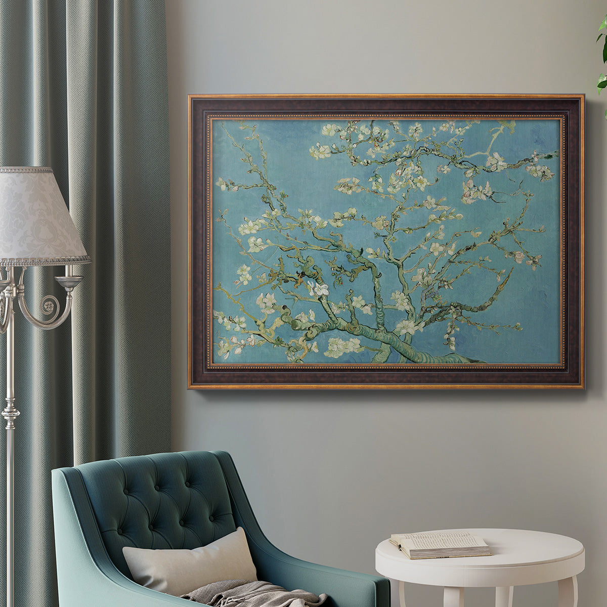 Impressionist flowering almond branch painting by Vincent van Gogh in an ornate bronzed mahogany wood frame displayed in a bright interior setting.