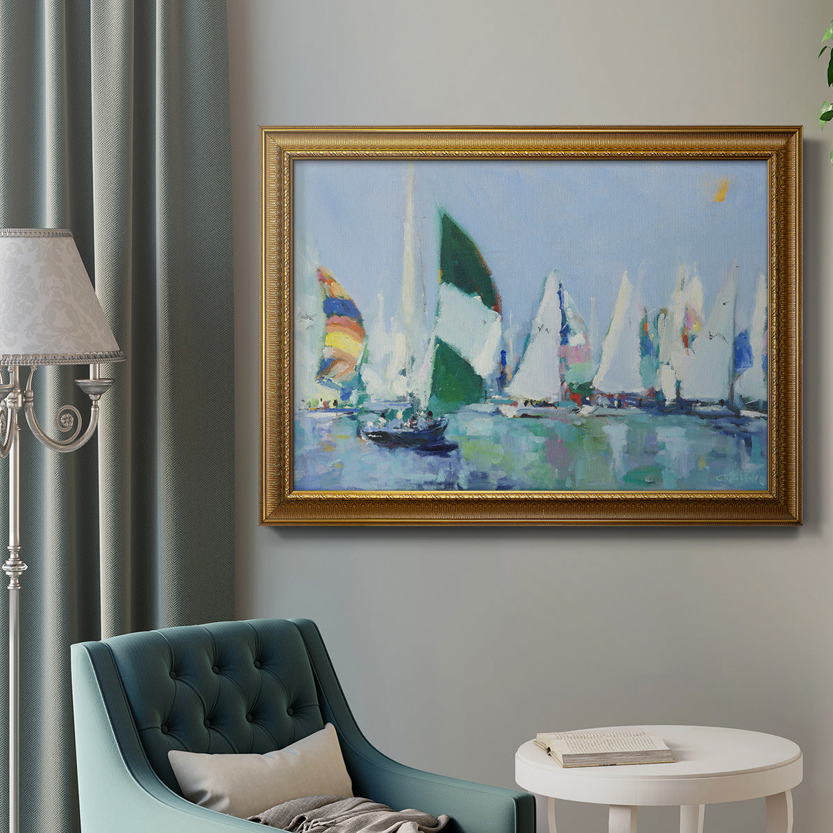 Coastal harbor watercolor painting in an ornate traditional gold frame displayed in a neutral interior setting.