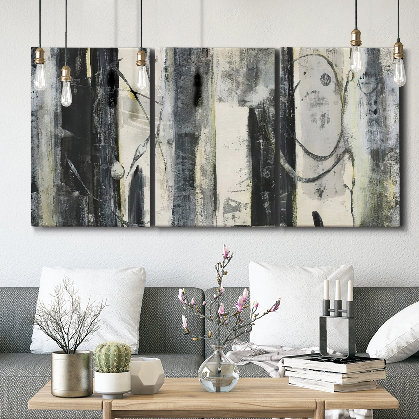 Three-panel canvas wall art featuring vertical abstract tree forms, displayed in a modern living room above seating.