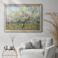 Impressionist white-blossomed orchard landscape by Vincent van Gogh in an ornate champagne frame displayed in a bright interior setting.