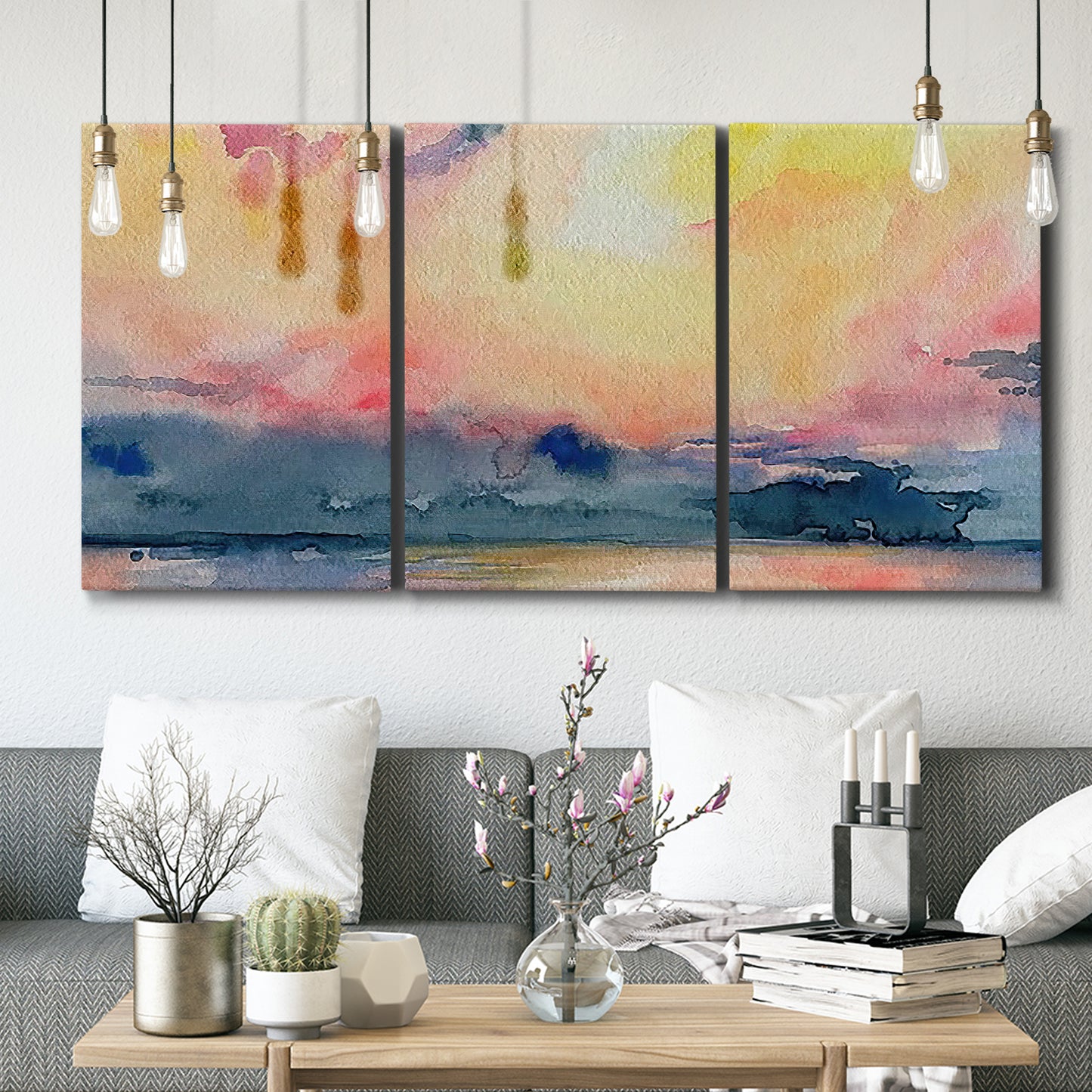 Three-panel canvas wall art featuring prismatic watercolor coastal seascape, displayed in a modern living room above seating.