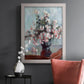 Impressionist chrysanthemum floral painting by Claude Monet in an ornate weathered white frame displayed in a dark-toned interior setting.