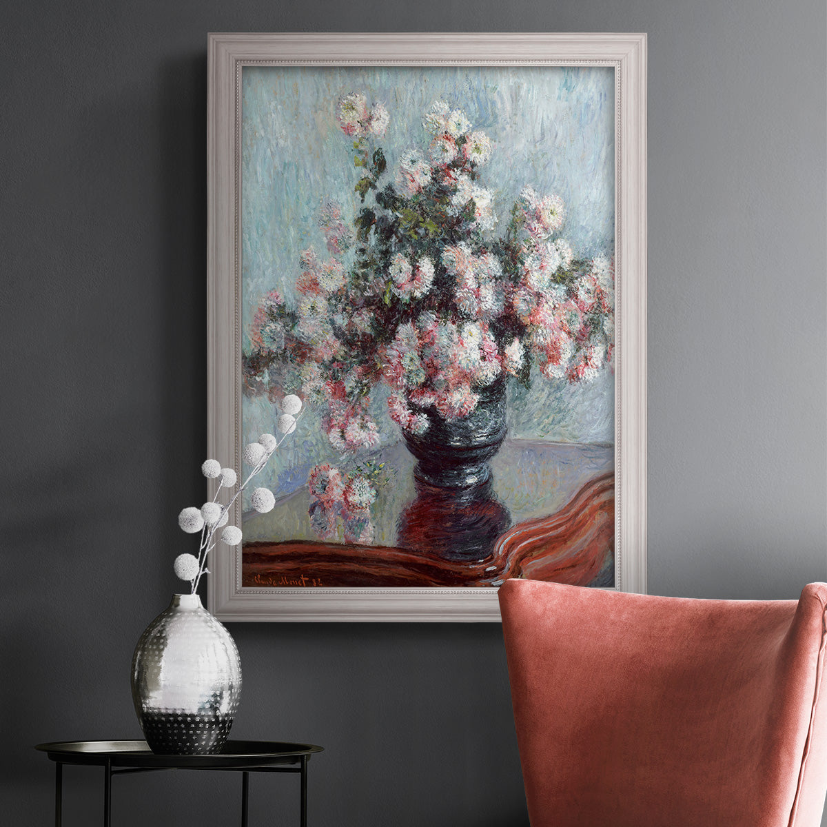 Impressionist chrysanthemum floral painting by Claude Monet in an ornate weathered white frame displayed in a dark-toned interior setting.