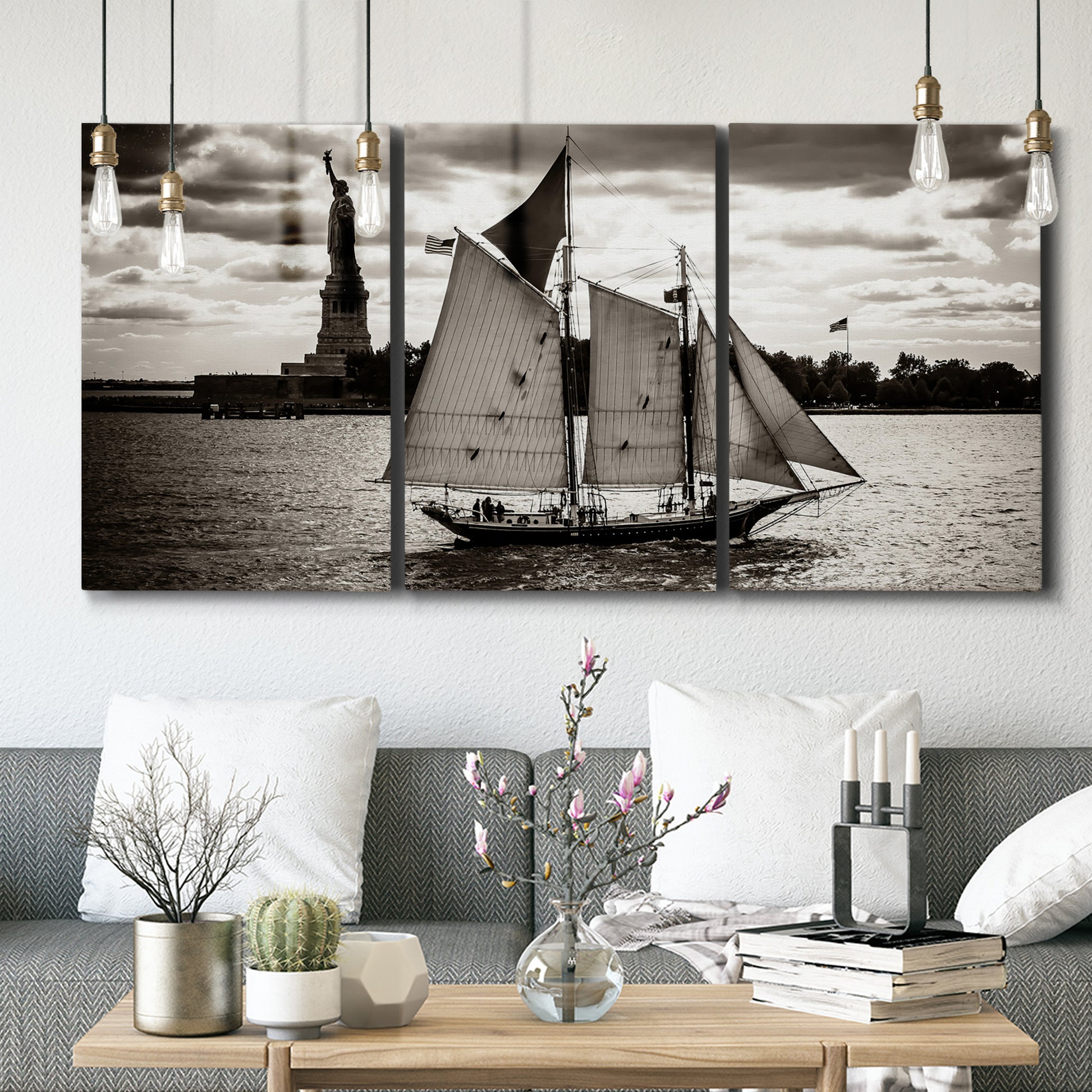 Three-panel canvas wall art featuring historic sailing ships photograph, displayed in a modern living room above seating.