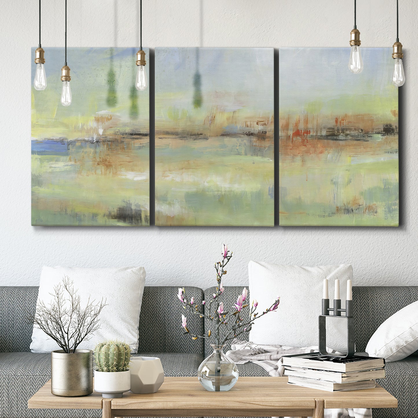 Three-panel canvas wall art featuring layered abstract transitional textures, displayed in a modern living room above seating.