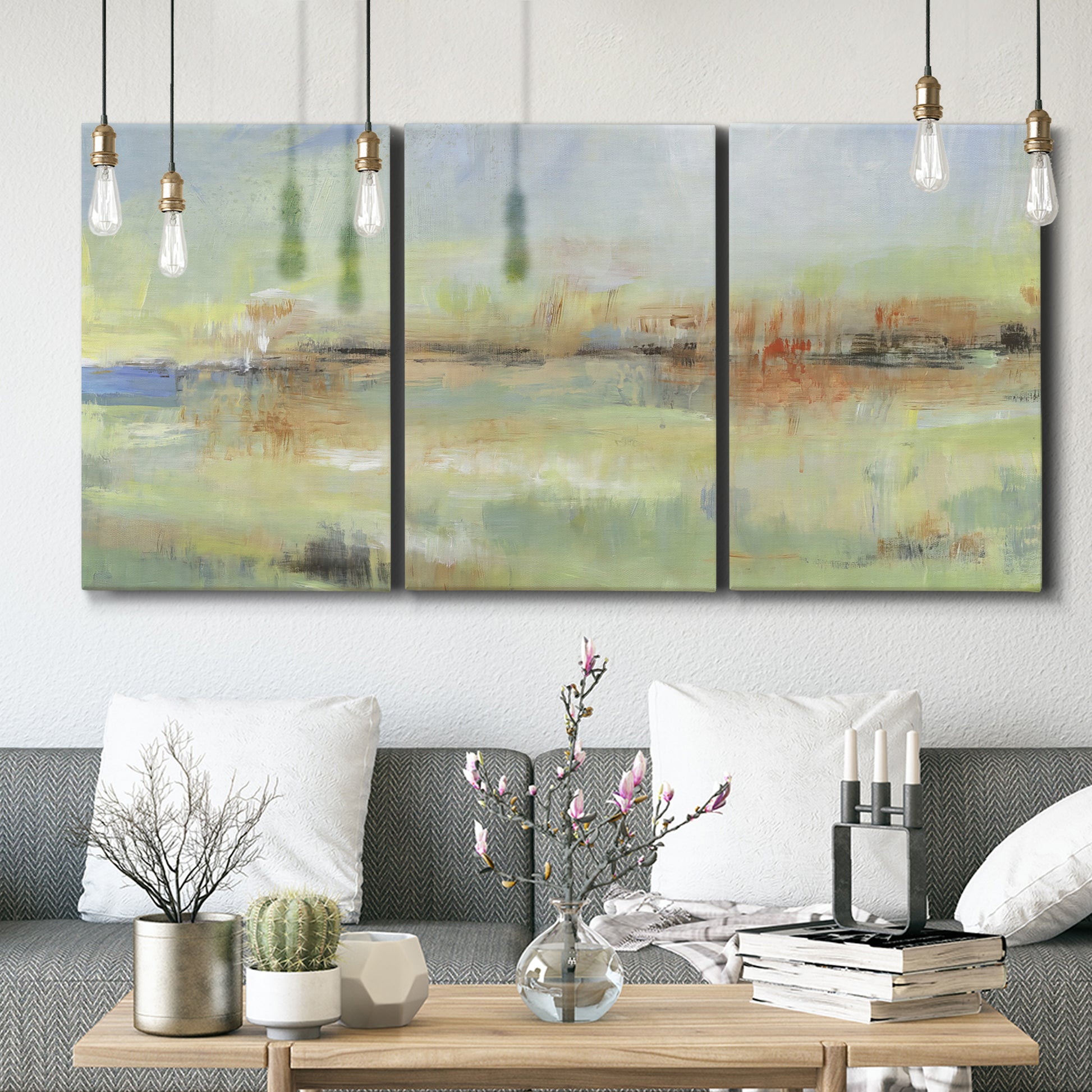 Three-panel canvas wall art featuring layered abstract transitional textures, displayed in a modern living room above seating.
