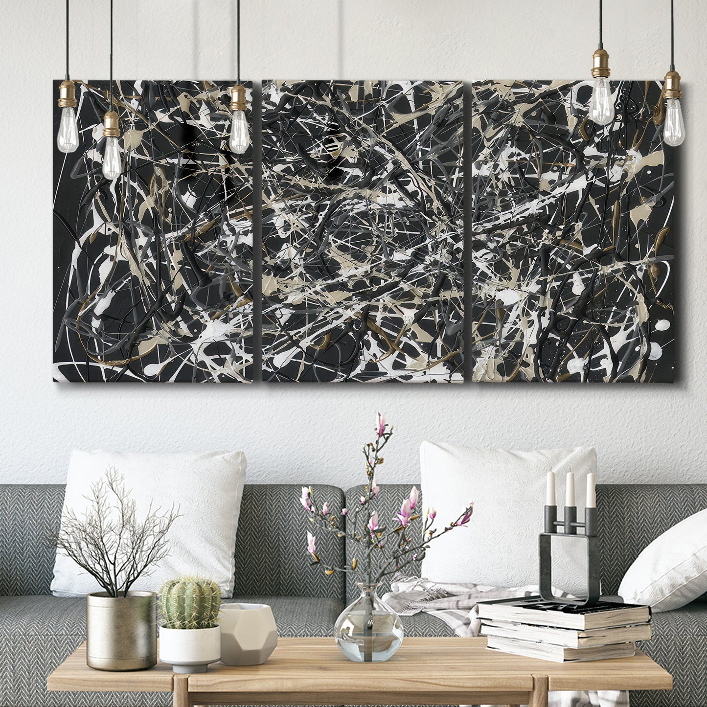 Three-panel canvas wall art featuring energetic expressionist abstract splatter, displayed in a modern living room above seating.