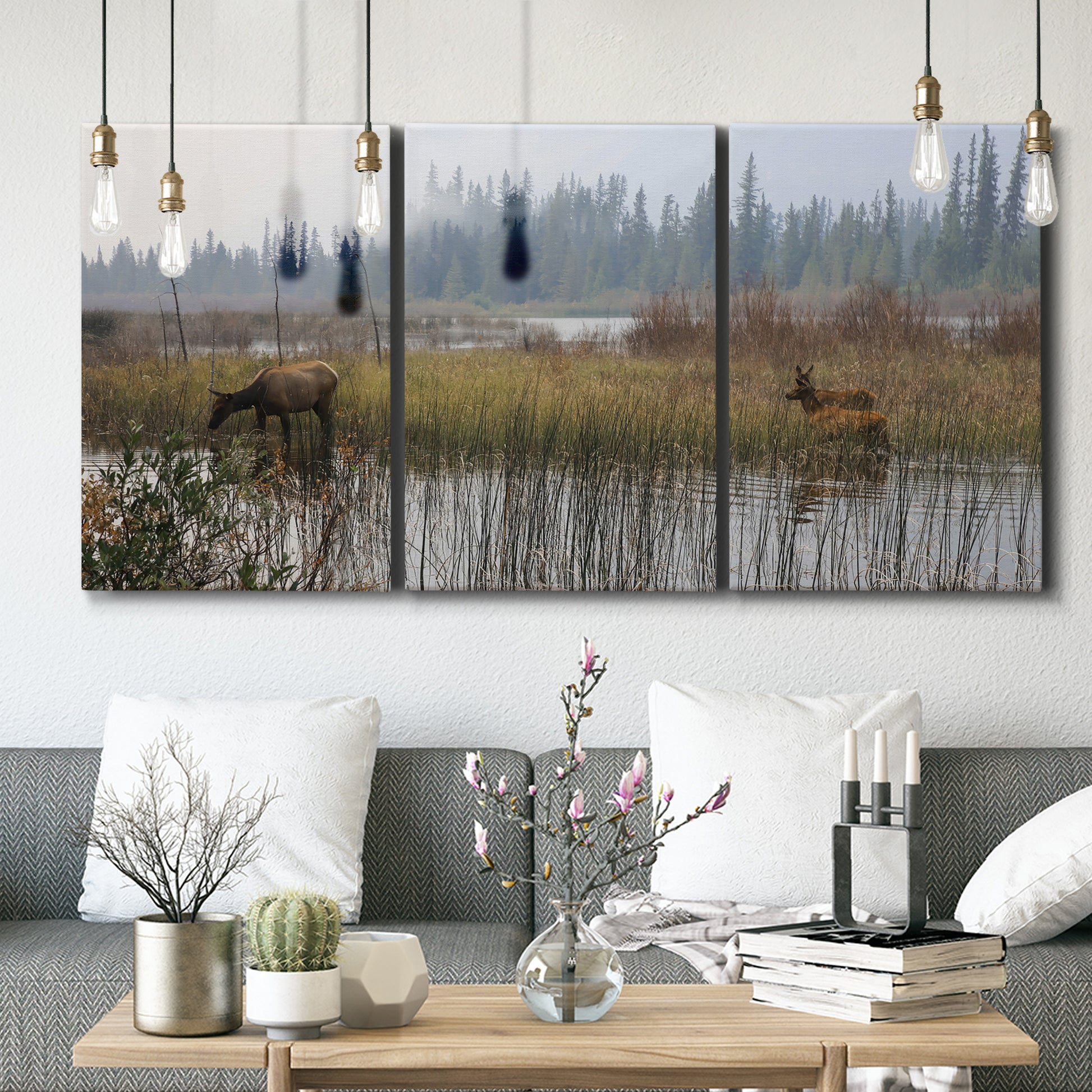 Three-panel canvas wall art featuring wildlife walking through open field, displayed in a modern living room above seating.