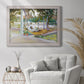 Impressionist leisure portrait scene by John Singer Sargent in an ornate weathered white frame displayed in a bright interior setting.