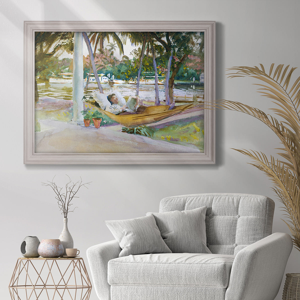 Impressionist leisure portrait scene by John Singer Sargent in an ornate weathered white frame displayed in a bright interior setting.