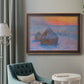 Impressionist haystack scene at sunset by Claude Monet in an ornate bronzed mahogany wood frame displayed in a bright interior setting.