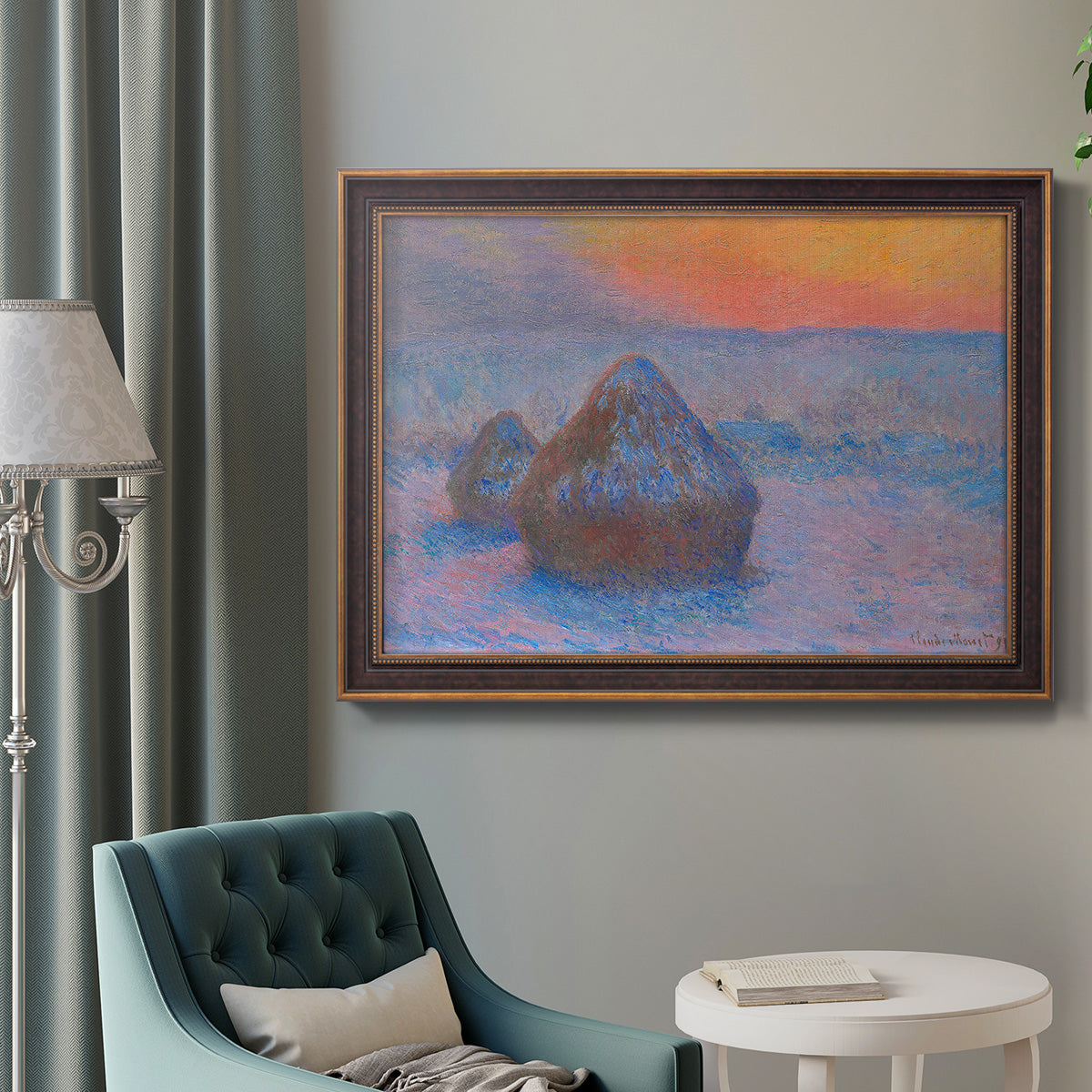Impressionist haystack scene at sunset by Claude Monet in an ornate bronzed mahogany wood frame displayed in a bright interior setting.