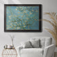 Impressionist flowering almond branch painting by Vincent van Gogh in an ornate black frame with gilded inner detail displayed in a bright interior setting.