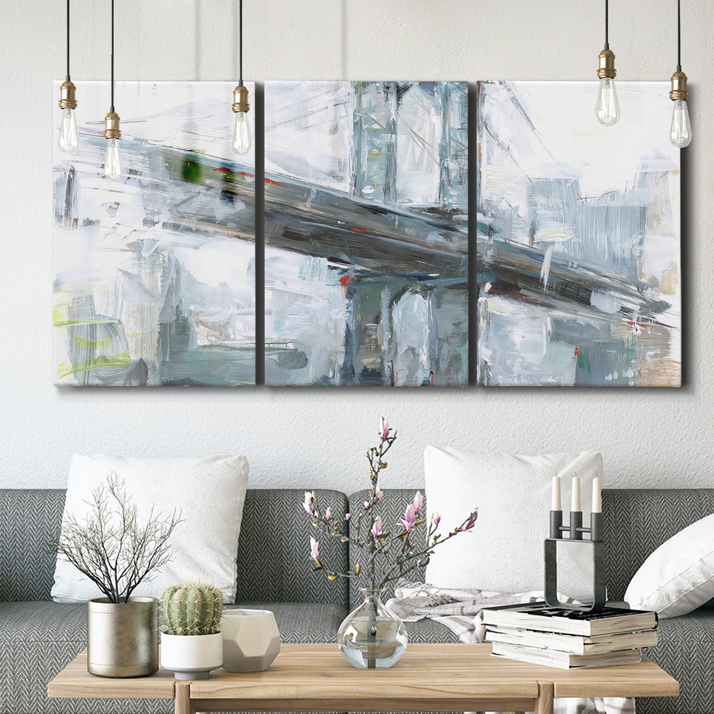 Three-panel canvas wall art featuring urban cityscape with architectural forms, displayed in a modern living room above seating.