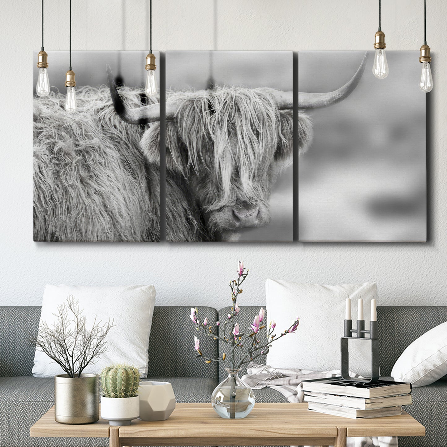 Three-panel canvas wall art featuring large highland cow portrait, displayed in a modern living room above seating.