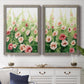 Set of two gray barnwood framed canvas prints depicting a coordinated art pair of a field of pink coral and white flowers rendered as luminous impressionistic floral paintings above a dining room sideboard.