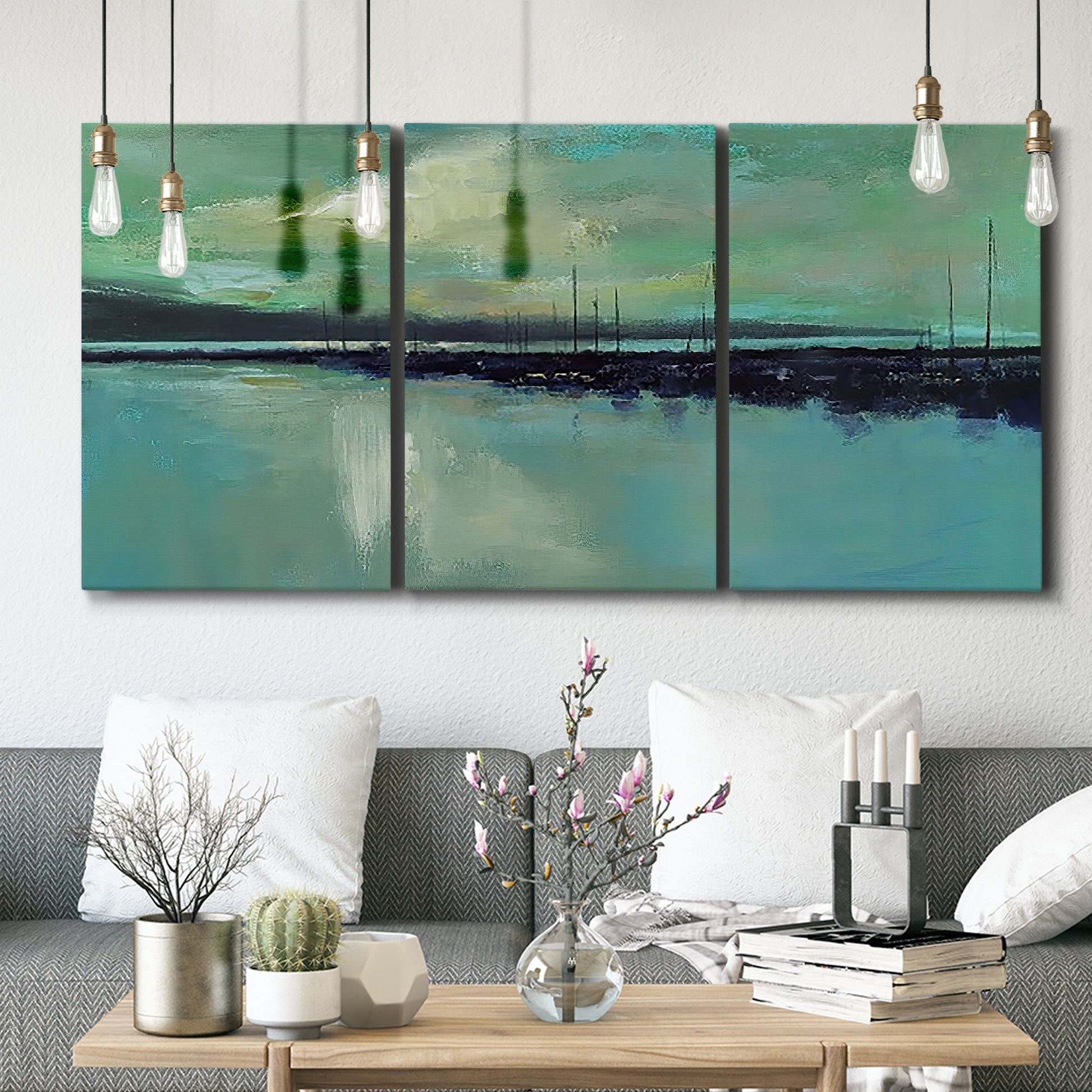 Three-panel canvas wall art featuring calm harbor water with glowing horizon, displayed in a modern living room above seating.