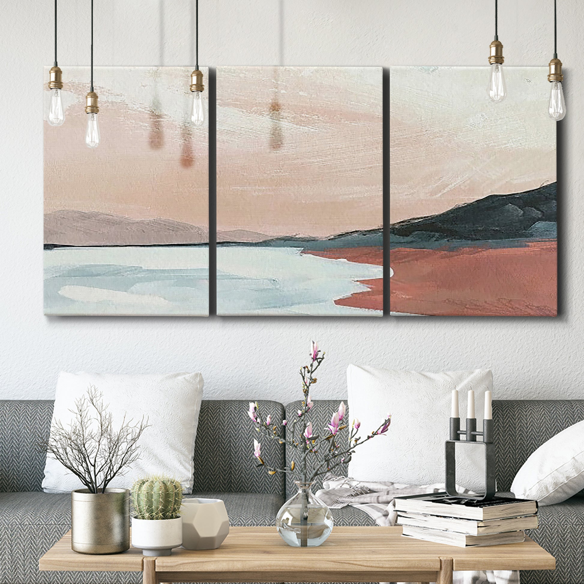 Three-panel canvas wall art featuring quiet coastline with distant horizon, displayed in a modern living room above seating.