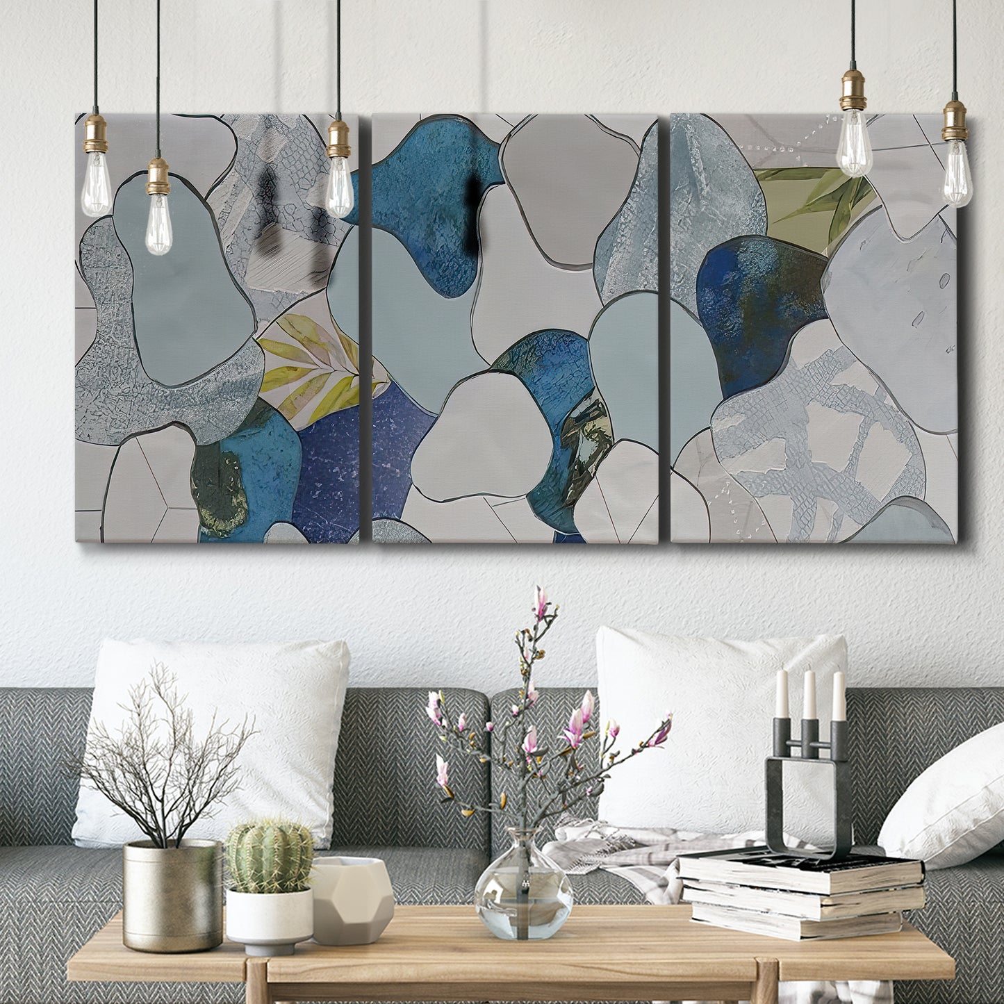 Three-panel canvas wall art featuring mid century geometric pink abstraction, displayed in a modern living room above seating.