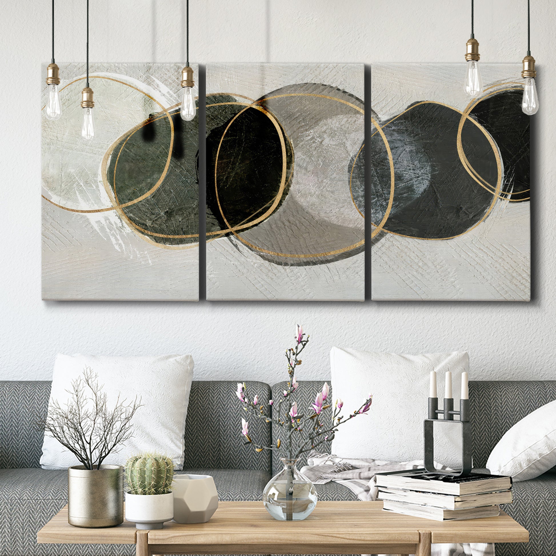 Three-panel canvas wall art featuring smooth abstract river stone forms, displayed in a modern living room above seating.