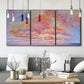 Three-panel canvas wall art featuring peaceful tropical inspired landscape, displayed in a modern living room above seating.