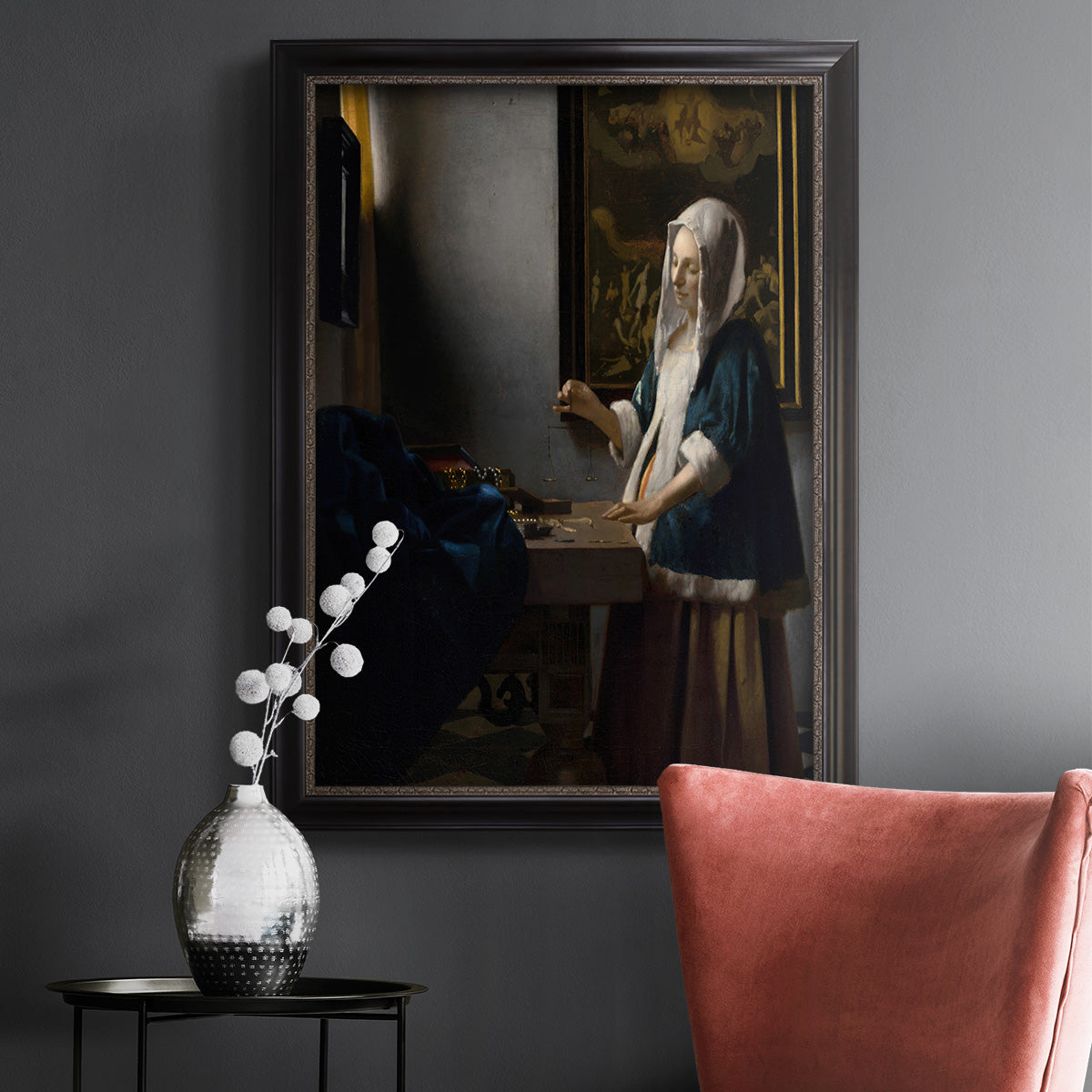 Quiet interior genre scene of a woman with scales by Johannes Vermeer in an ornate black frame with gilded inner detail displayed in a dark-toned interior setting.
