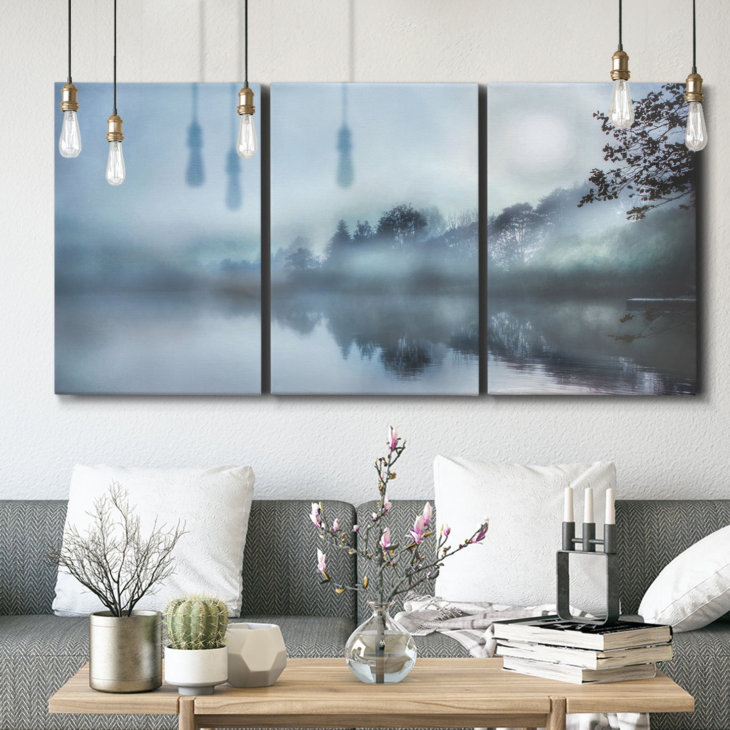 Three-panel canvas wall art featuring calm waters at sunrise photograph, displayed in a modern living room above seating.