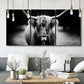 Three-panel canvas wall art featuring black and white cattle portrait, displayed in a modern living room above seating.