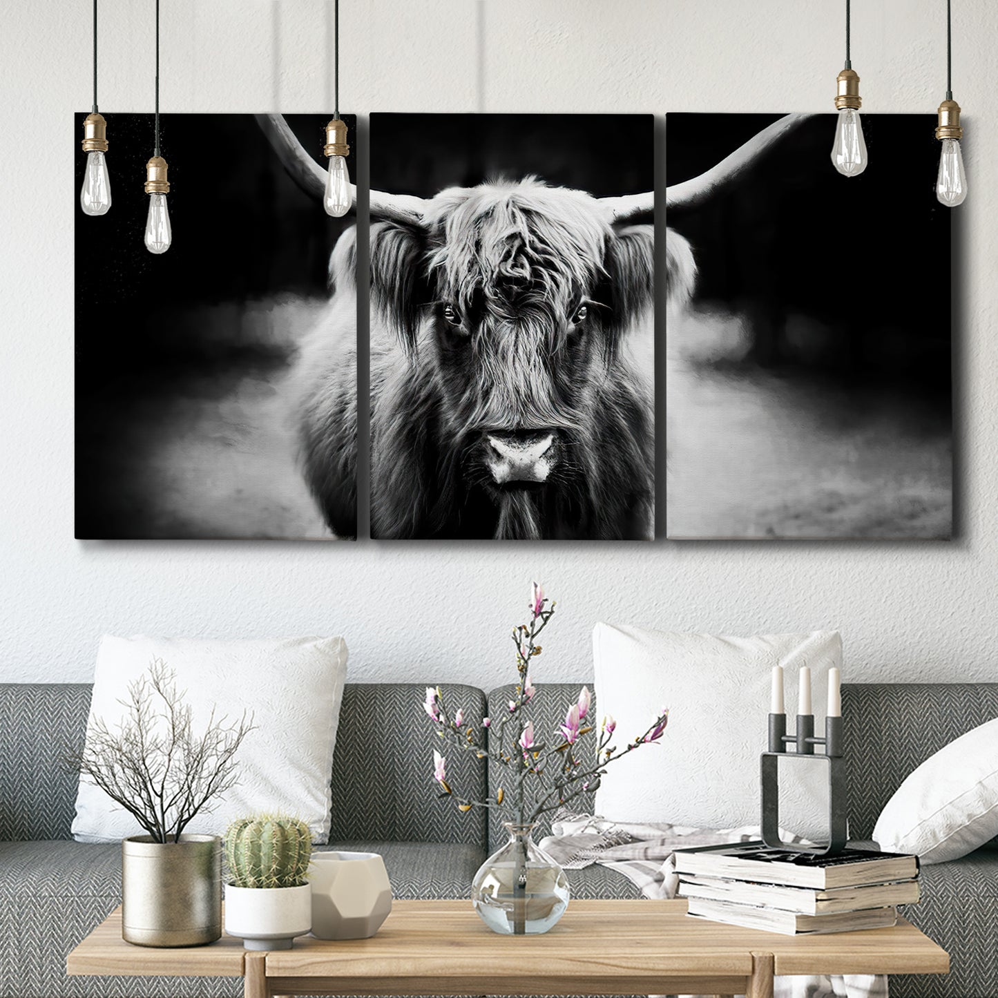 Three-panel canvas wall art featuring black and white cattle portrait, displayed in a modern living room above seating.
