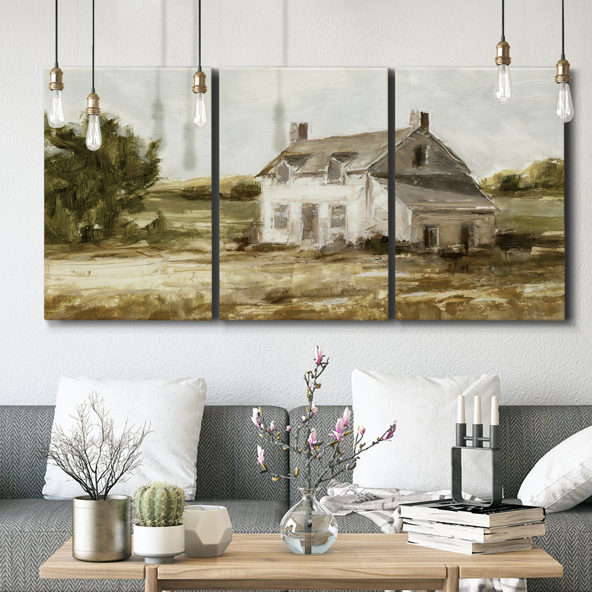 Three-panel canvas wall art featuring rural farmhouse harvest landscape, displayed in a modern living room above seating.