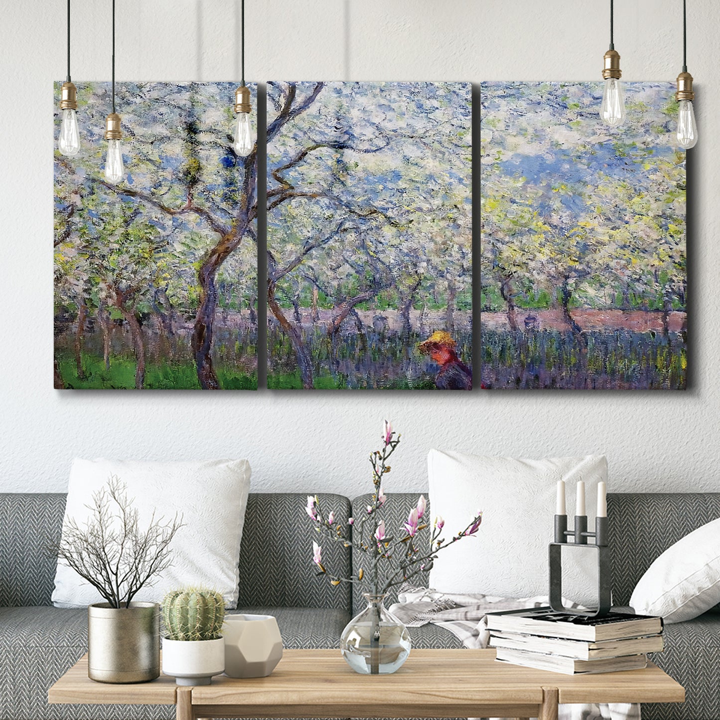 Three-panel canvas wall art featuring fresh spring countryside landscape, displayed in a modern living room above seating.