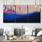 Three-panel canvas wall art featuring smooth abstract sunset color gradient, displayed in a modern living room above seating.
