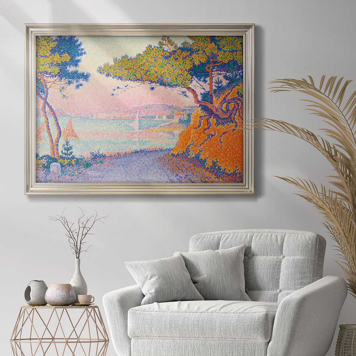 Pointillist coastal seascape by Paul Signac in an ornate champagne frame displayed in a bright interior setting.