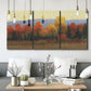Three-panel canvas wall art featuring autumn landscape changing foliage, displayed in a modern living room above seating.